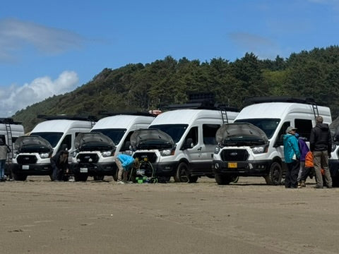 ford transit storyteller wolf pack overland event on the beach with upgraded suspension
