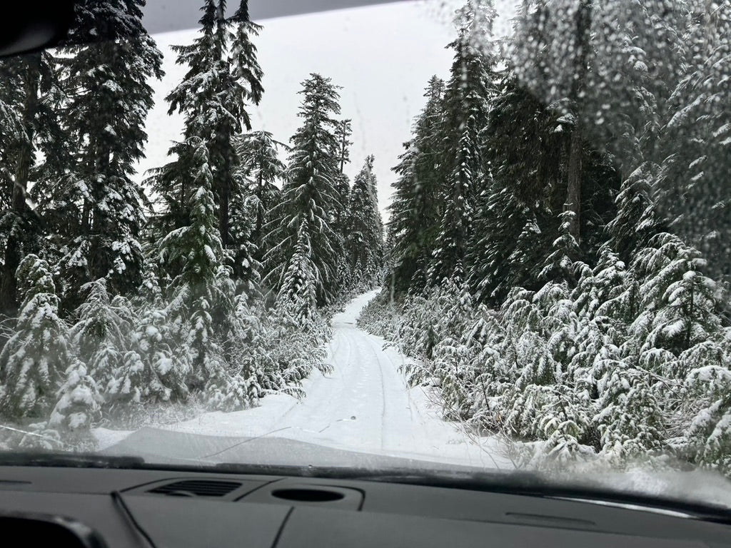 sprinter van driving a snow trail in snoqualmie pass after upgrades tires, wheels and suspension at wolf pack overland