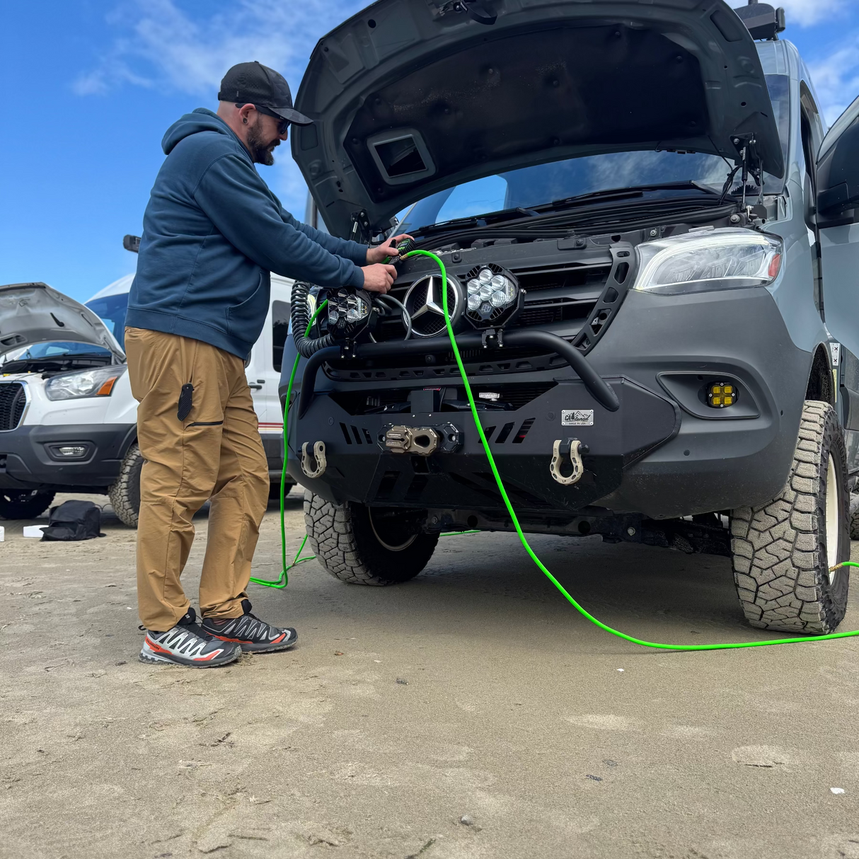 winnebago revel airing up and down tires on the beach