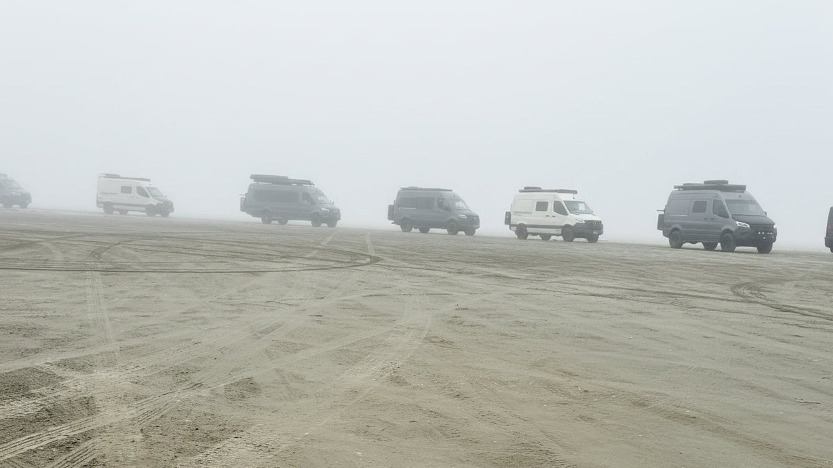 sprinter vans on a beach in washington with wolf pack overland