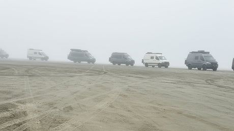 sprinter vans on a beach in washington with wolf pack overland