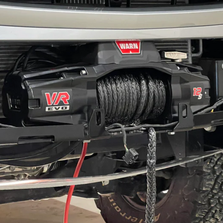 Front view of Warn VR EVO 12-S synthetic rope winch mounted on a Sprinter van in Seattle, ready for off-road recovery