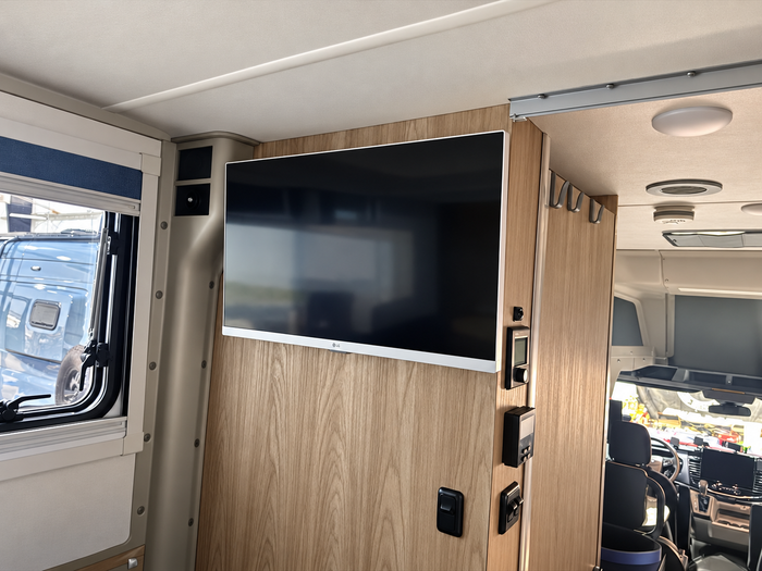 Clara's Wall-mounted LG television inside a Winnebago Ekko installed by Wolf Pack Overland
