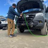 winnebago revel airing up and down tires on the beach